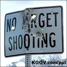 No Shooting sign all shot up