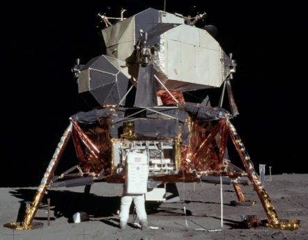 photo of lunar landing module with astronaut