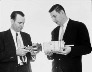 photo of Richter holding the low powered transmitter and subcarrier oscillators designed for Explorer III